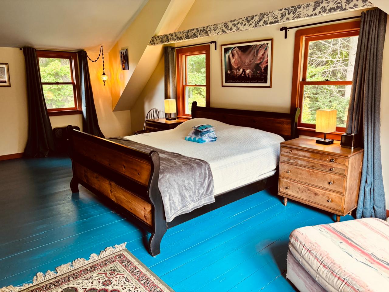 Sleigh bed on bright blue floors